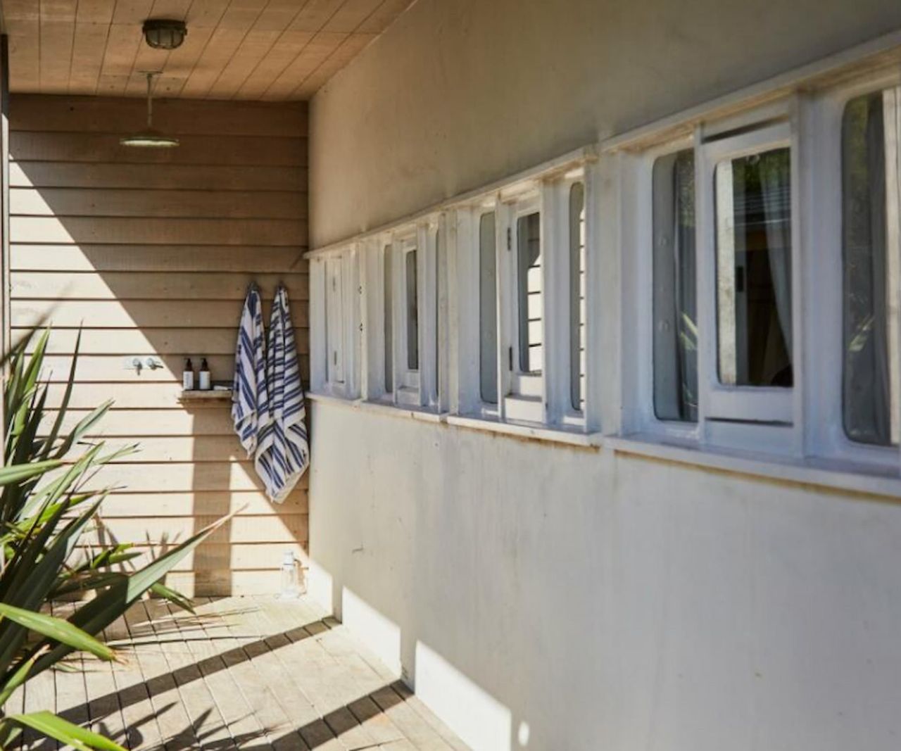 An outdoor shower on a backdoor porch
