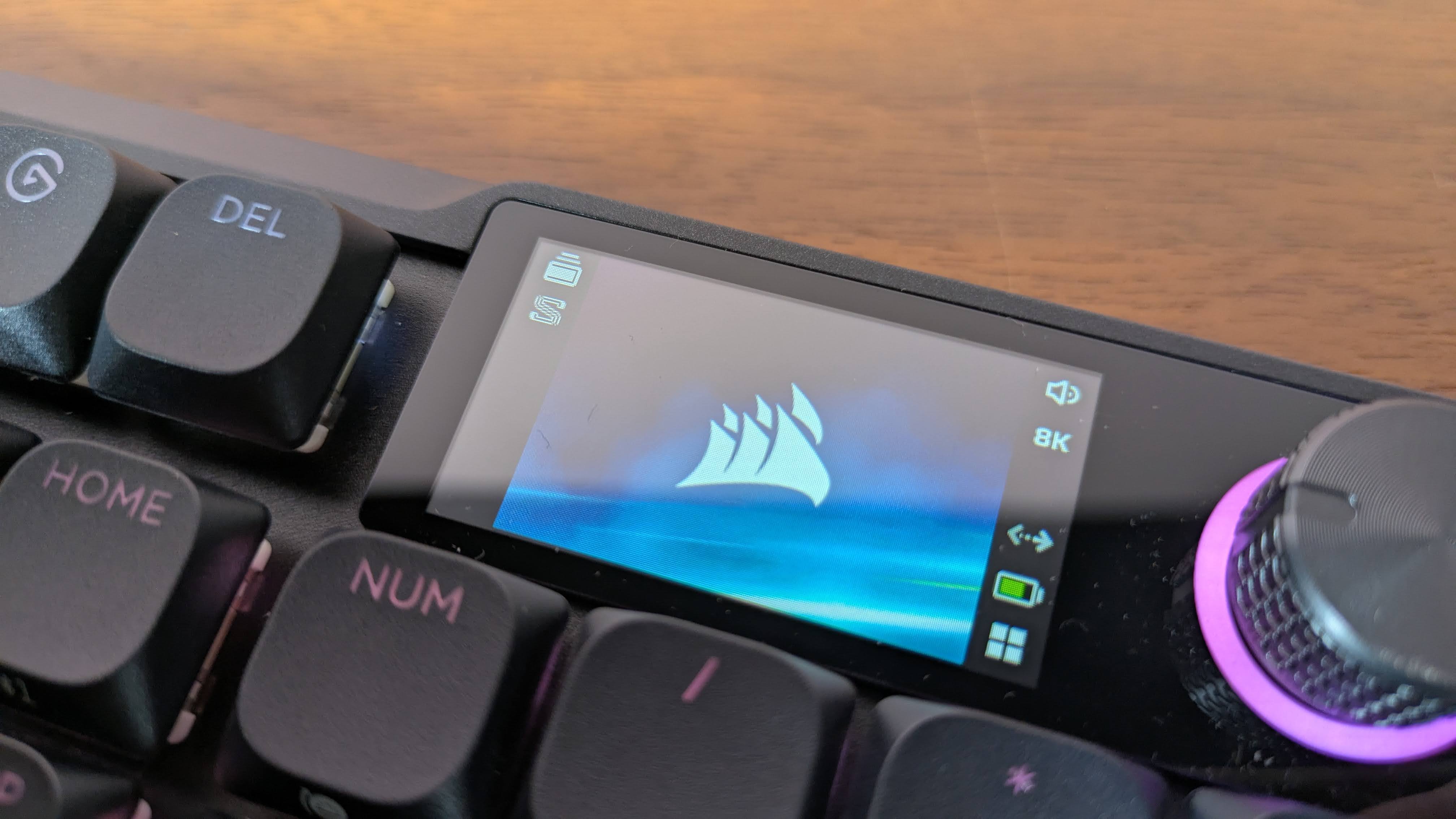 Close-up of screen on Corsair Vanguard Air 99 Wireless on brown desk