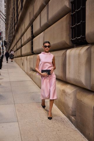 woman wearing pink dress and black heels