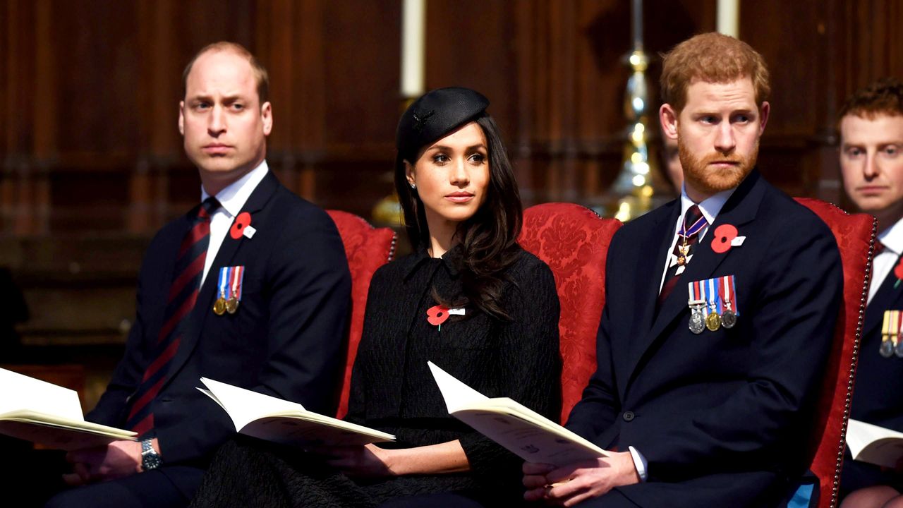 Prince William, Meghan Markle, and Prince Harry sit at a formal event.