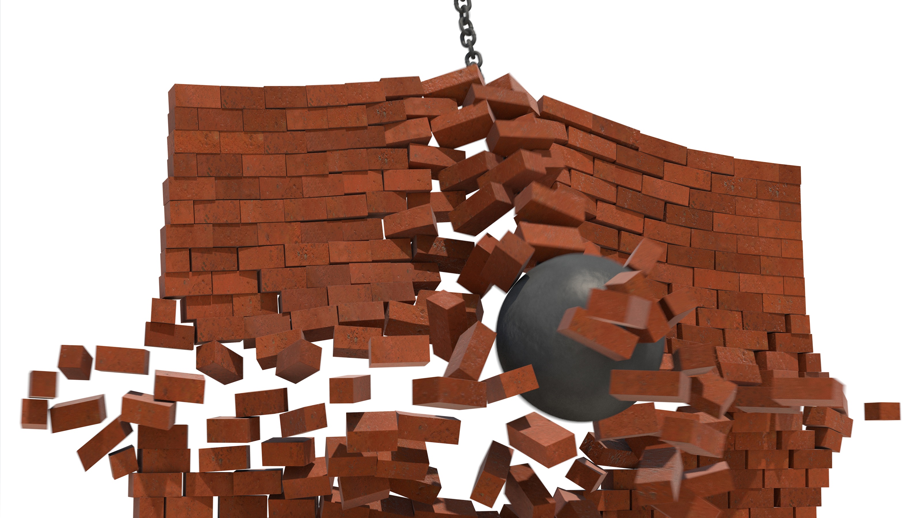 A wrecking ball breaks through a brick wall from behind.