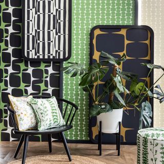 Layered boards wallpapered in bold designs in green and monochrome designs