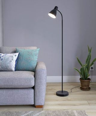 John Lewis & Partners Brandon Floor Lamp in grey living room with grey sofa and plant in corner
