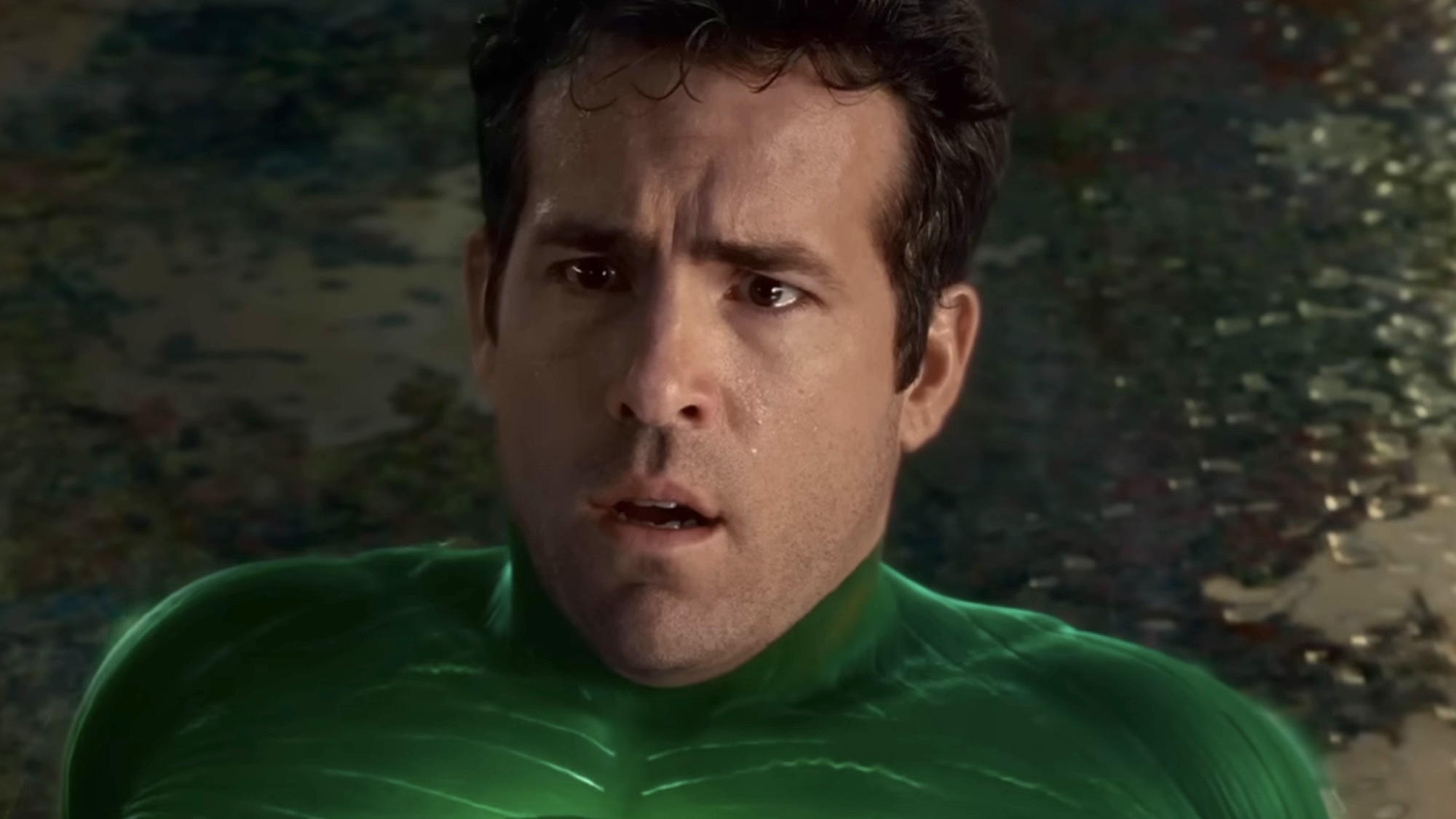 Ryan Reynolds looking confused while wearing the Green Lantern suit.
