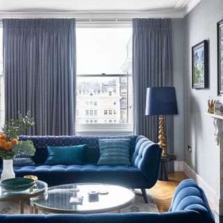 Grey living room with blue-grey curtains and furniture