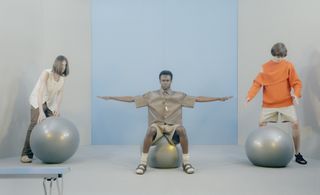 three men balancing on silver balls