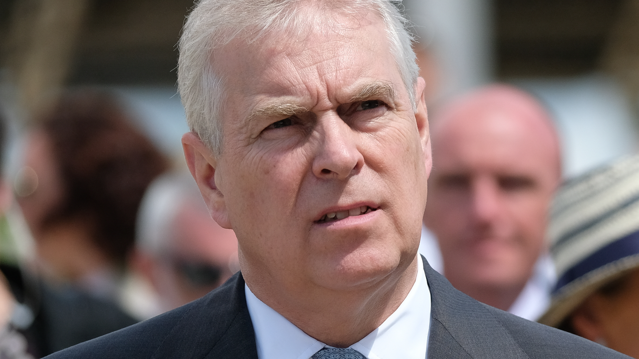 Prince Andrew has gray hair and looks pensive while wearing a suit