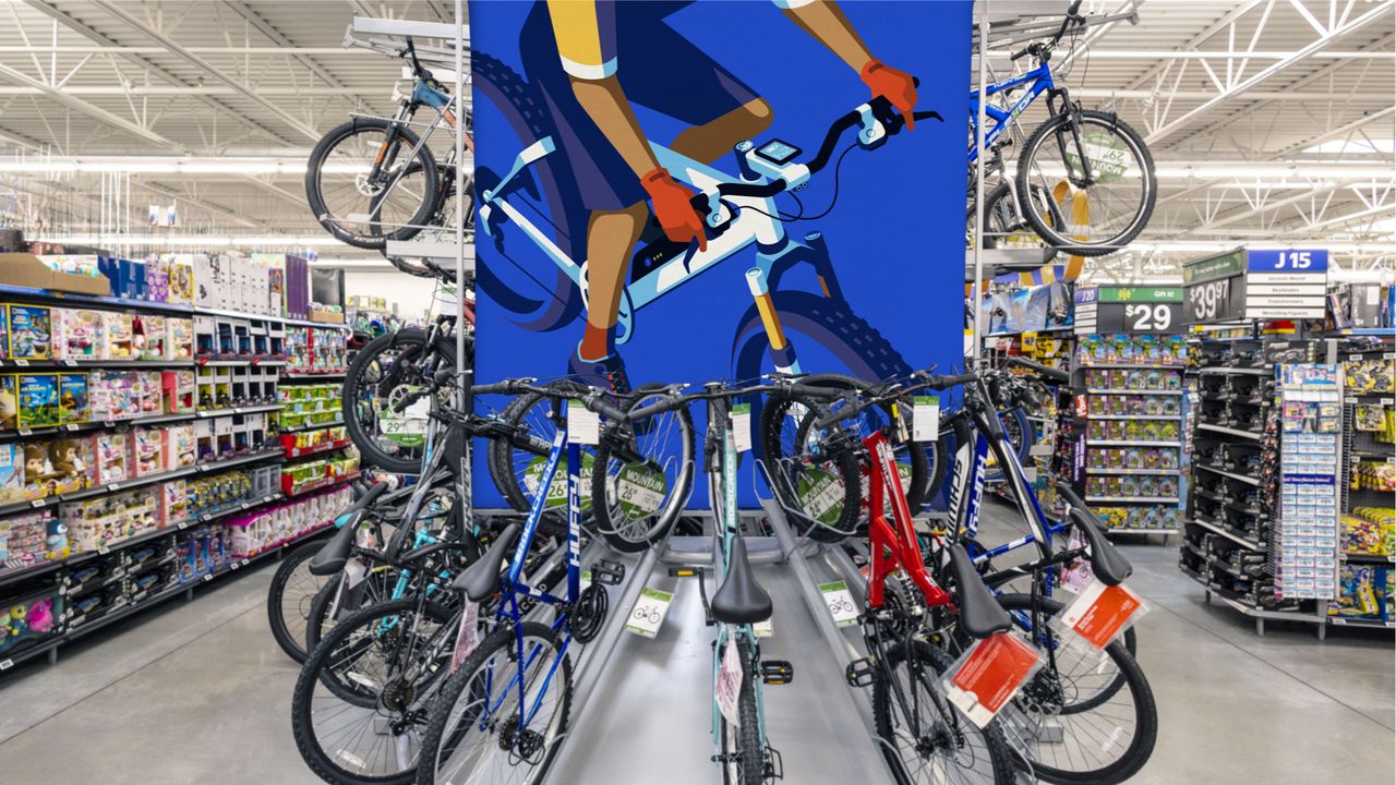 cycling illustration on a wall next to lots of bikes in Walmart