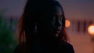 A young girl looks upset as she gazes off camera in Daughters.