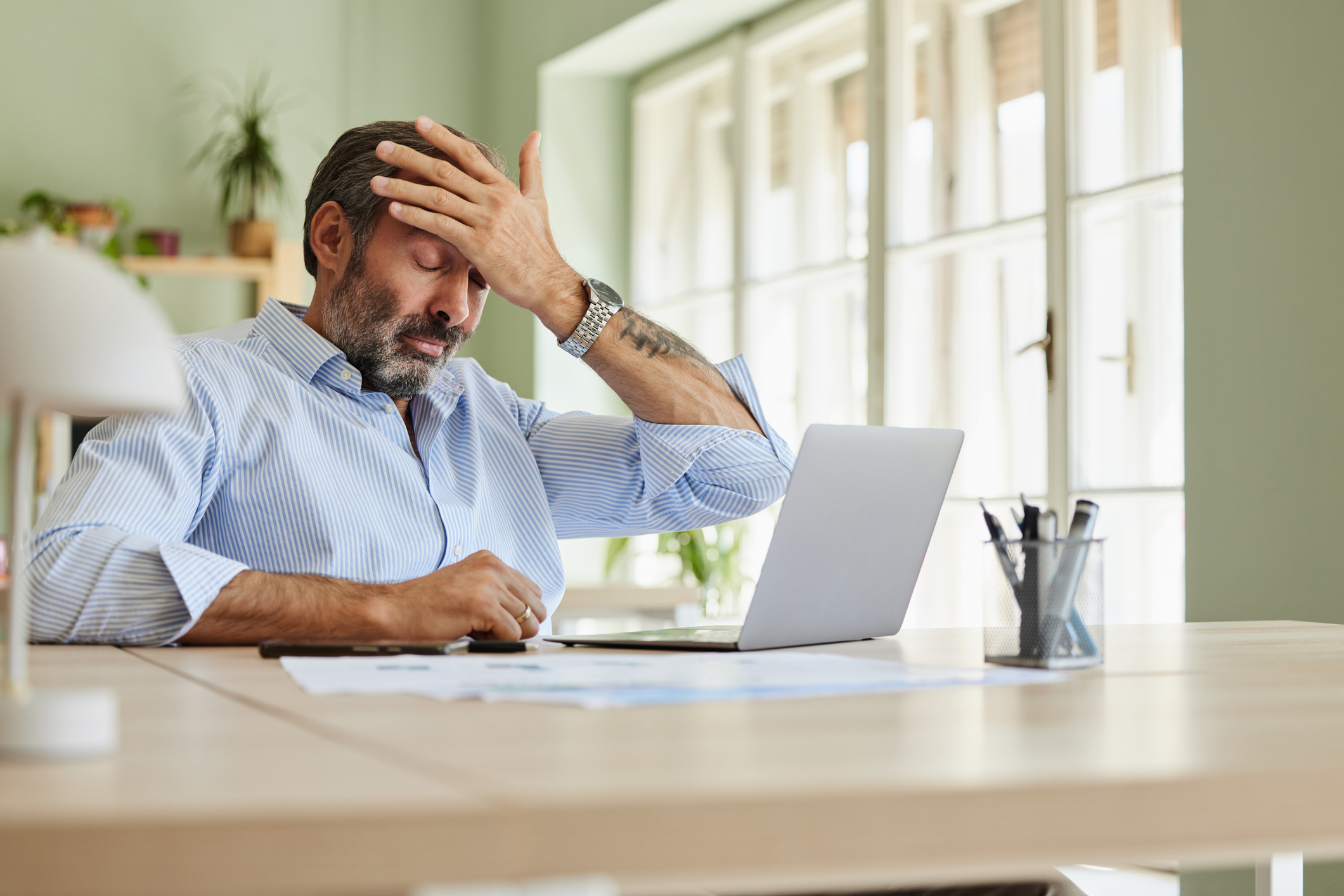 A frustrated man working at his computer. 