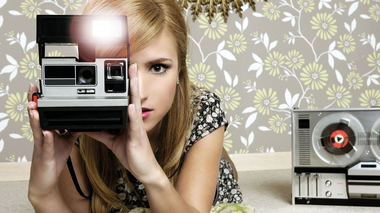 Woman with a Polaroid camera © Getty Images/iStockphoto