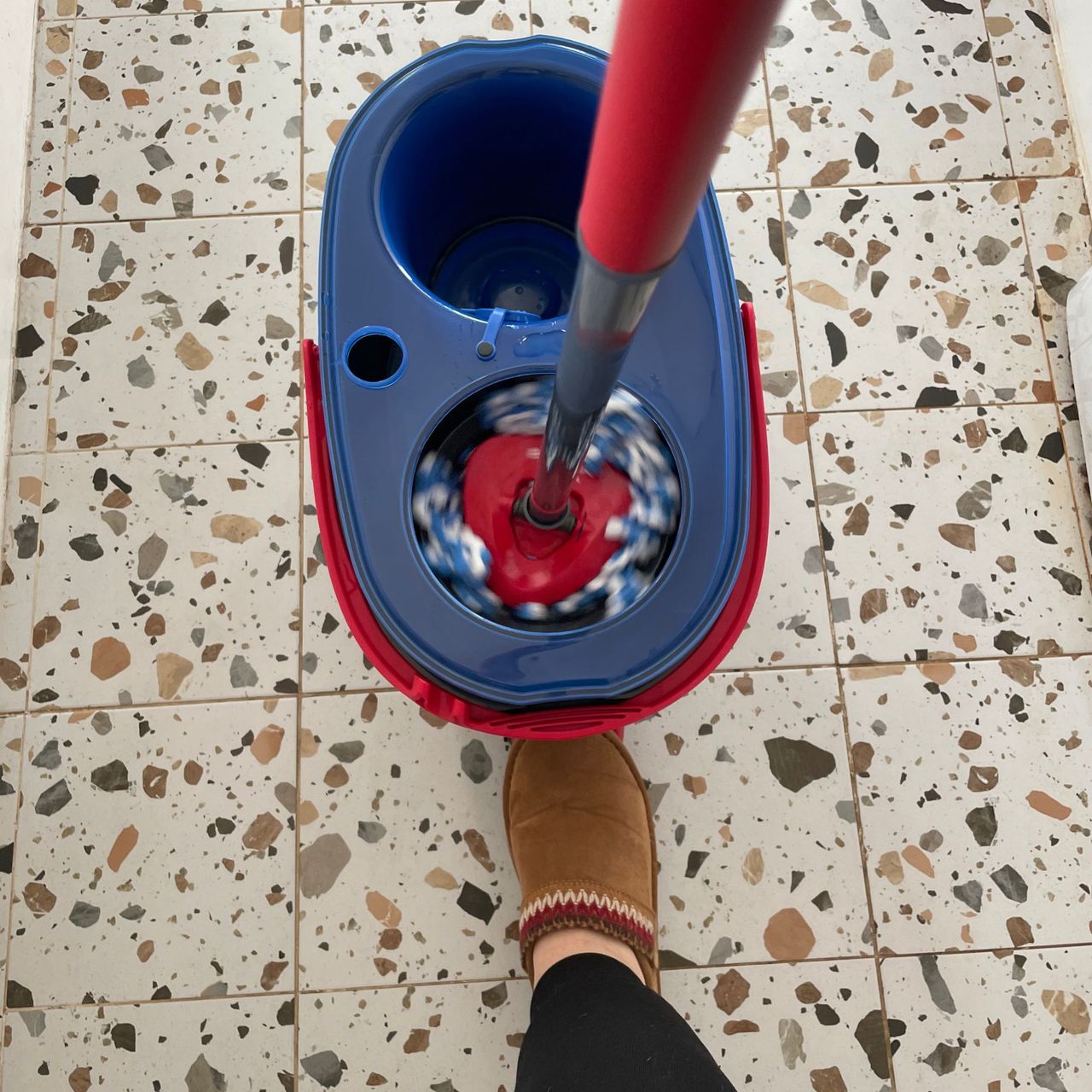 A foot pressing the pedal on the Vileda RinseClean Spin Mop &amp; Bucket System