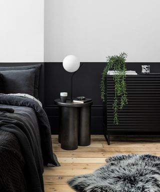 bedroom with black lower half wall and white upper half