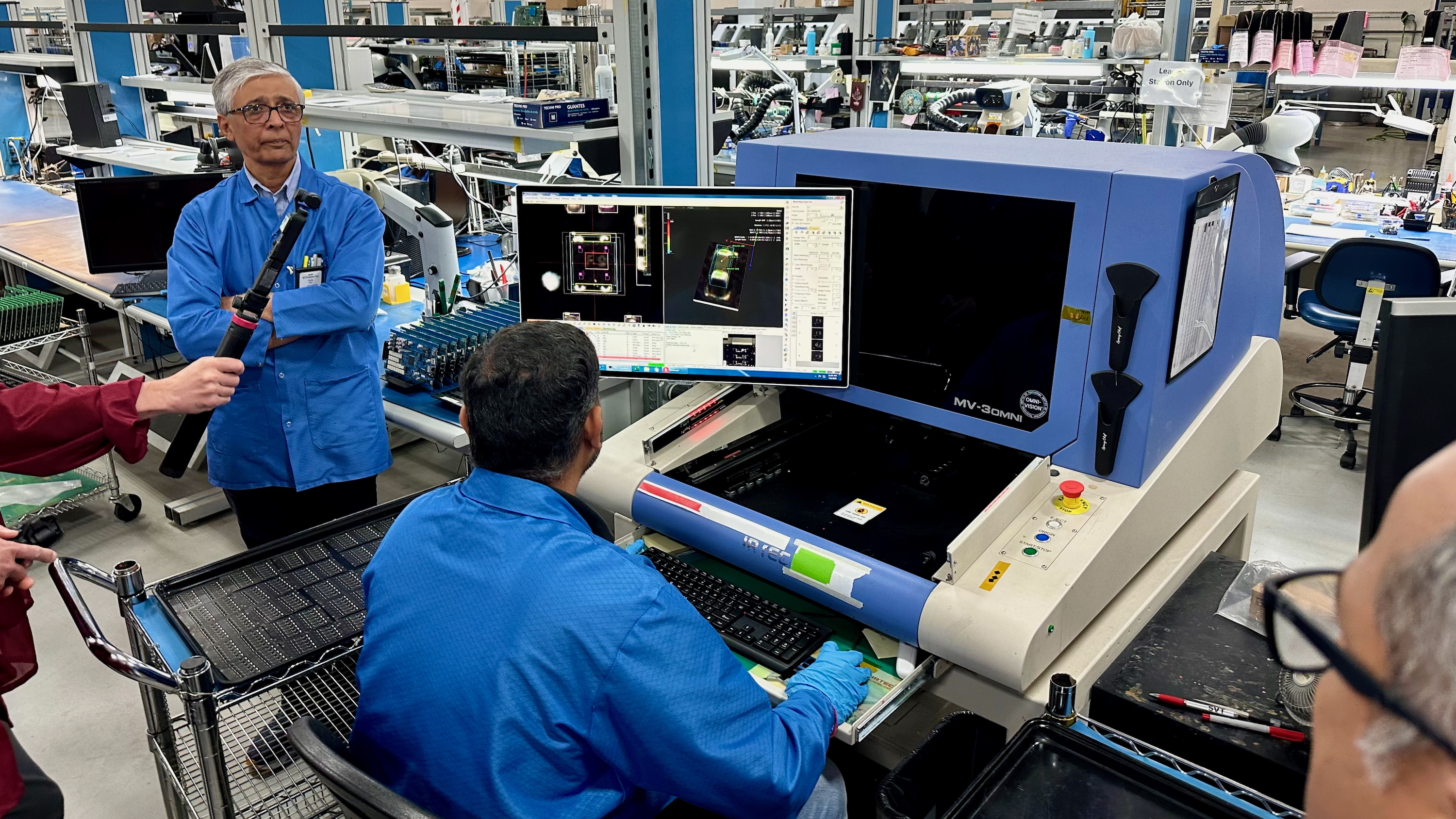 An Ultrahuman factory worker sits at a station for examining the external components of a Ring Air for defects.