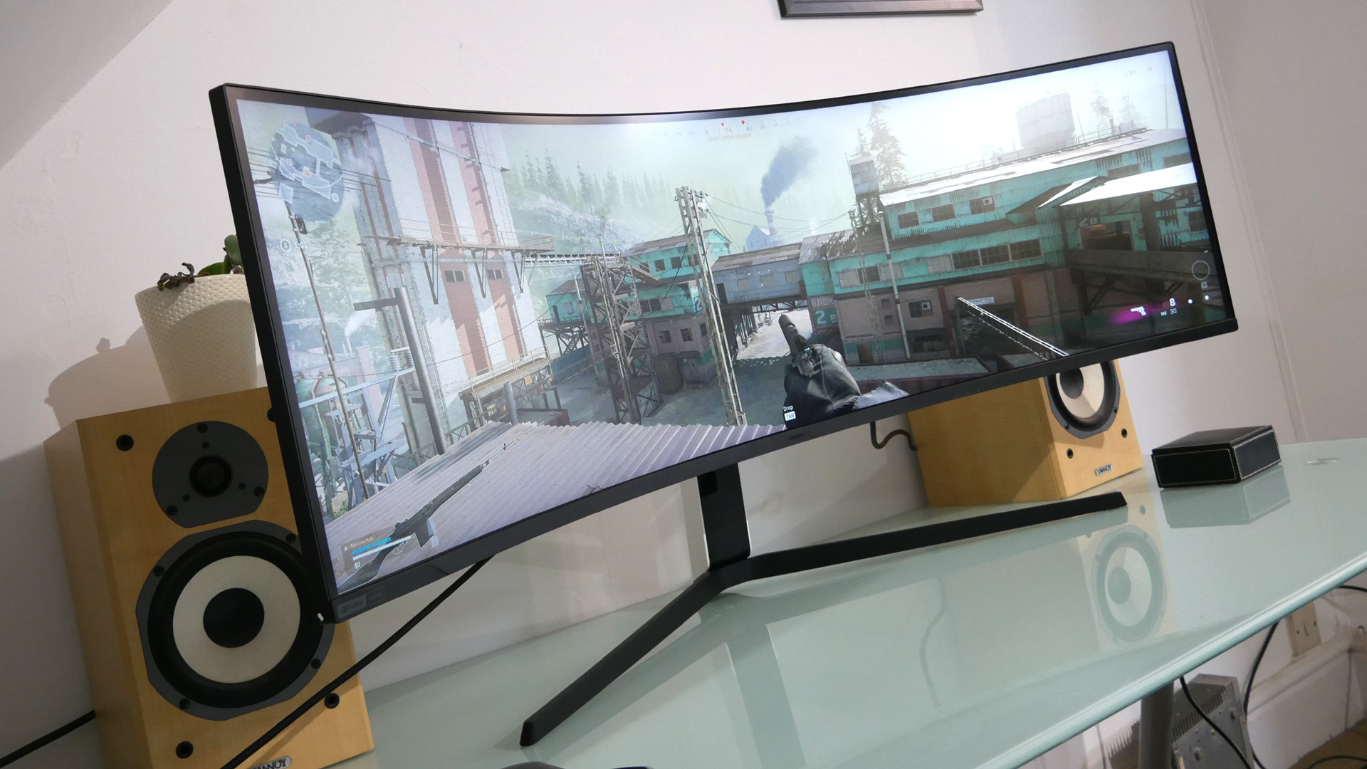 Samsung Odyssey Neo G9 from the front on a desk.