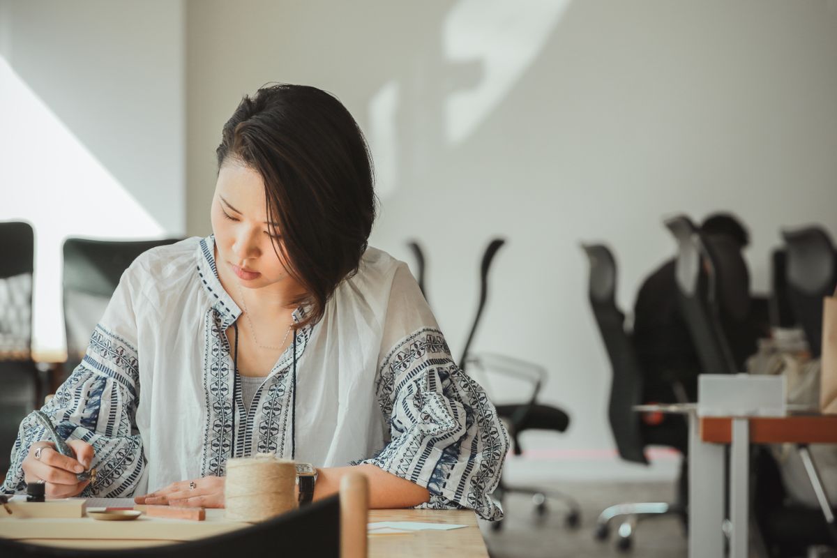 A woman working alone in a half-empty office