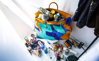 Colourful bag with hardware products, a coat hanging with paint stains on