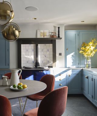 Brass light fittings in a blue painted kitchen