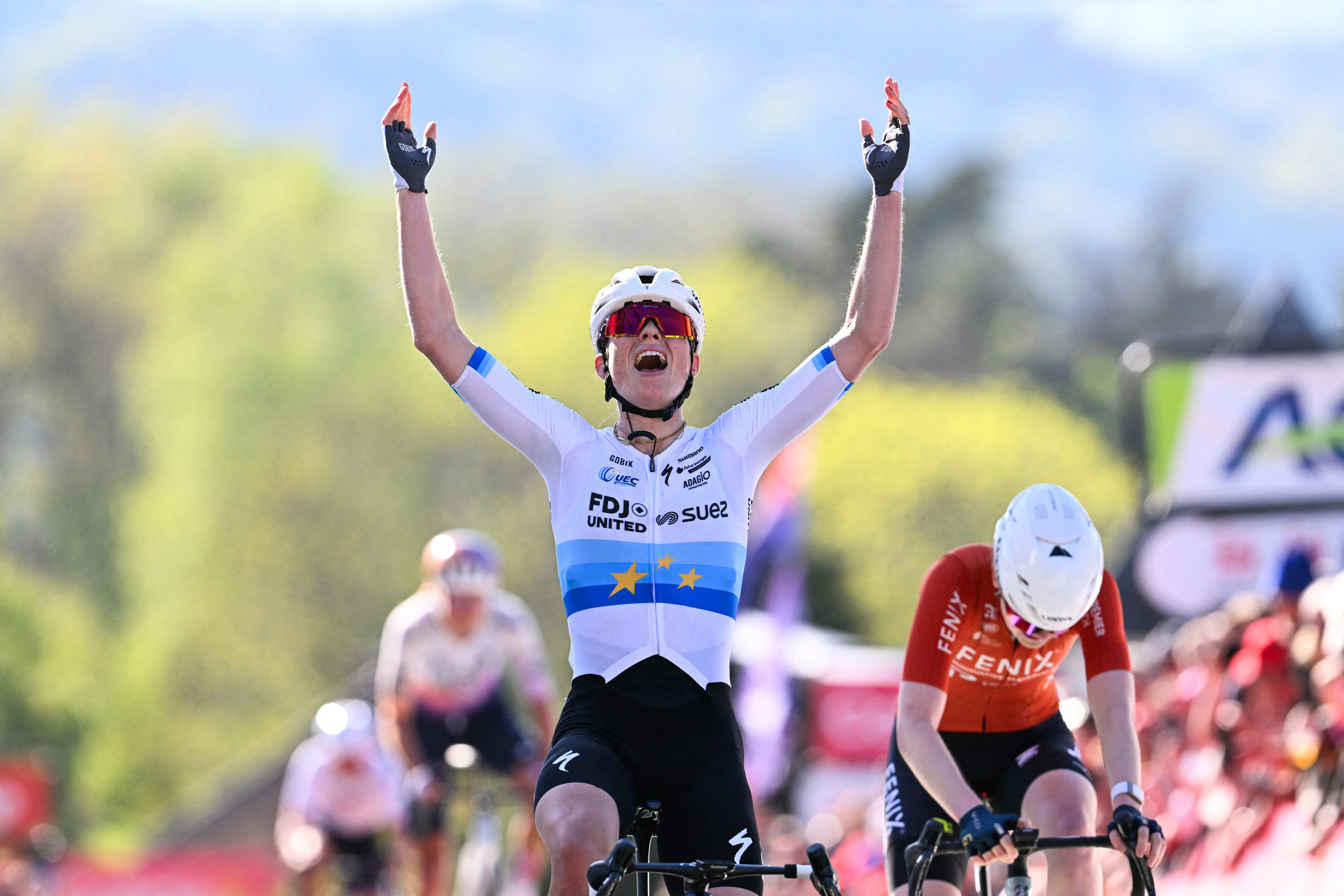 TOPSHOT - FDJ United - Suez's Dutch Demi Vollering celebrates as she crosses the finish line next to Fenix-Premier Tech's Dutch Puck Pieterse to win 'La Fleche Wallonne' one day cycling race, 141 km from Huy to Huy, on April 22, 2026. (Photo by JOHN THYS / AFP via Getty Images)