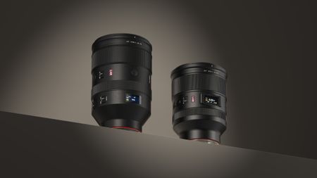 Viltrox 35mm F1.2 and 135mm F1.8 LAB lenses under spotlight on a diagonal surface, plain gray background
