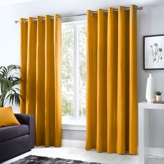 Curtains on window with white wall and sofa