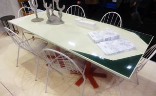 Red asterisk-shaped foot table with white chairs