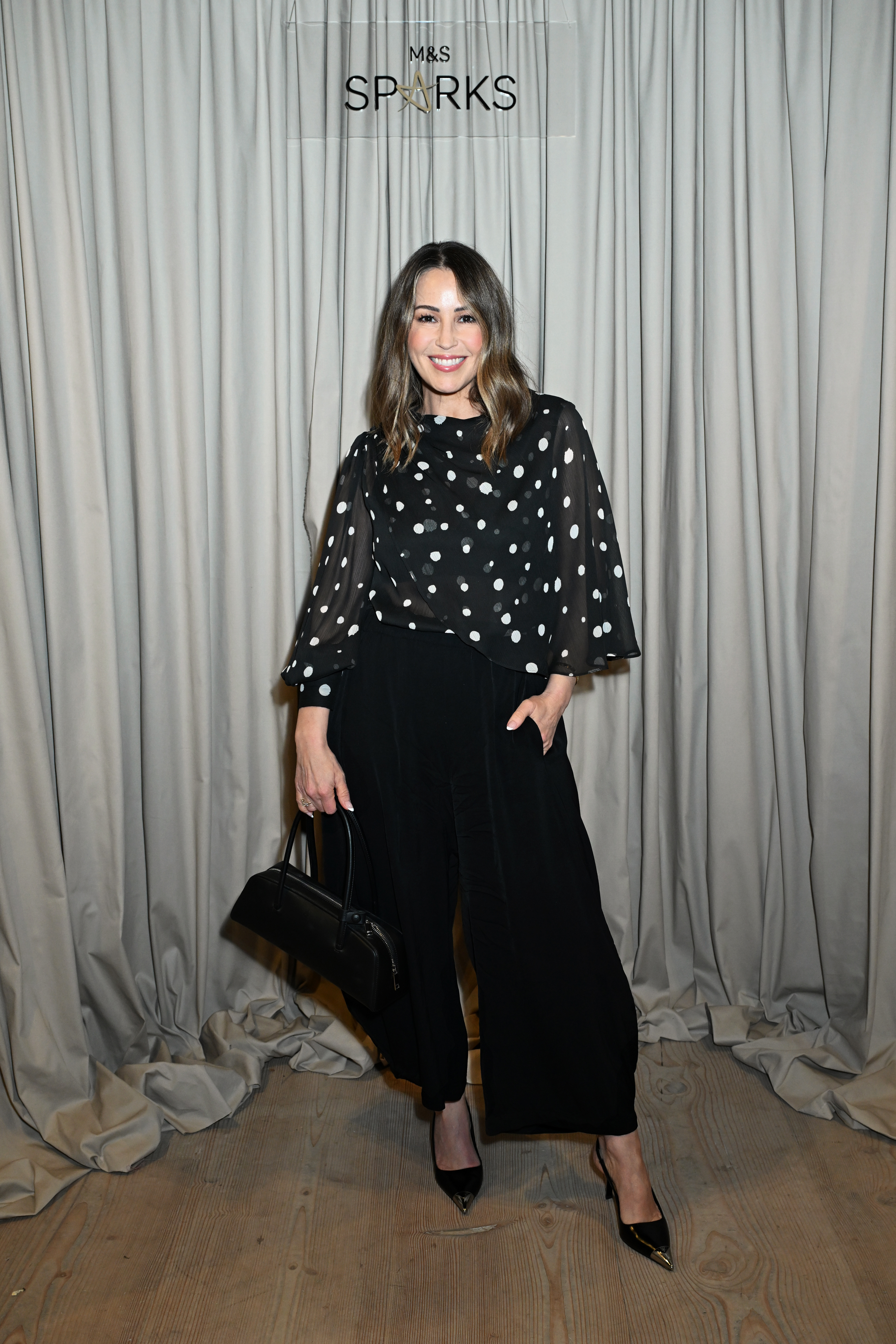 Rachel Stevens wearing a polka dot top and black trousers