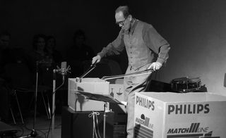 Man creating music from a cardboard box