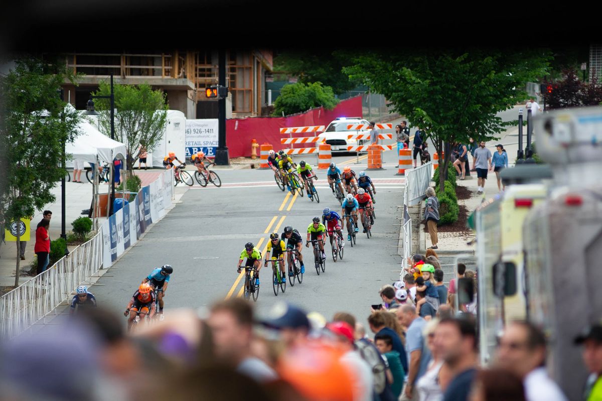 Fans watch as the mens peloton heads back into town at the Winston-Salem Cycling