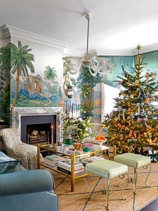 Living room with de Gournay wallpaper and a Christmas tree decorated with ribbons