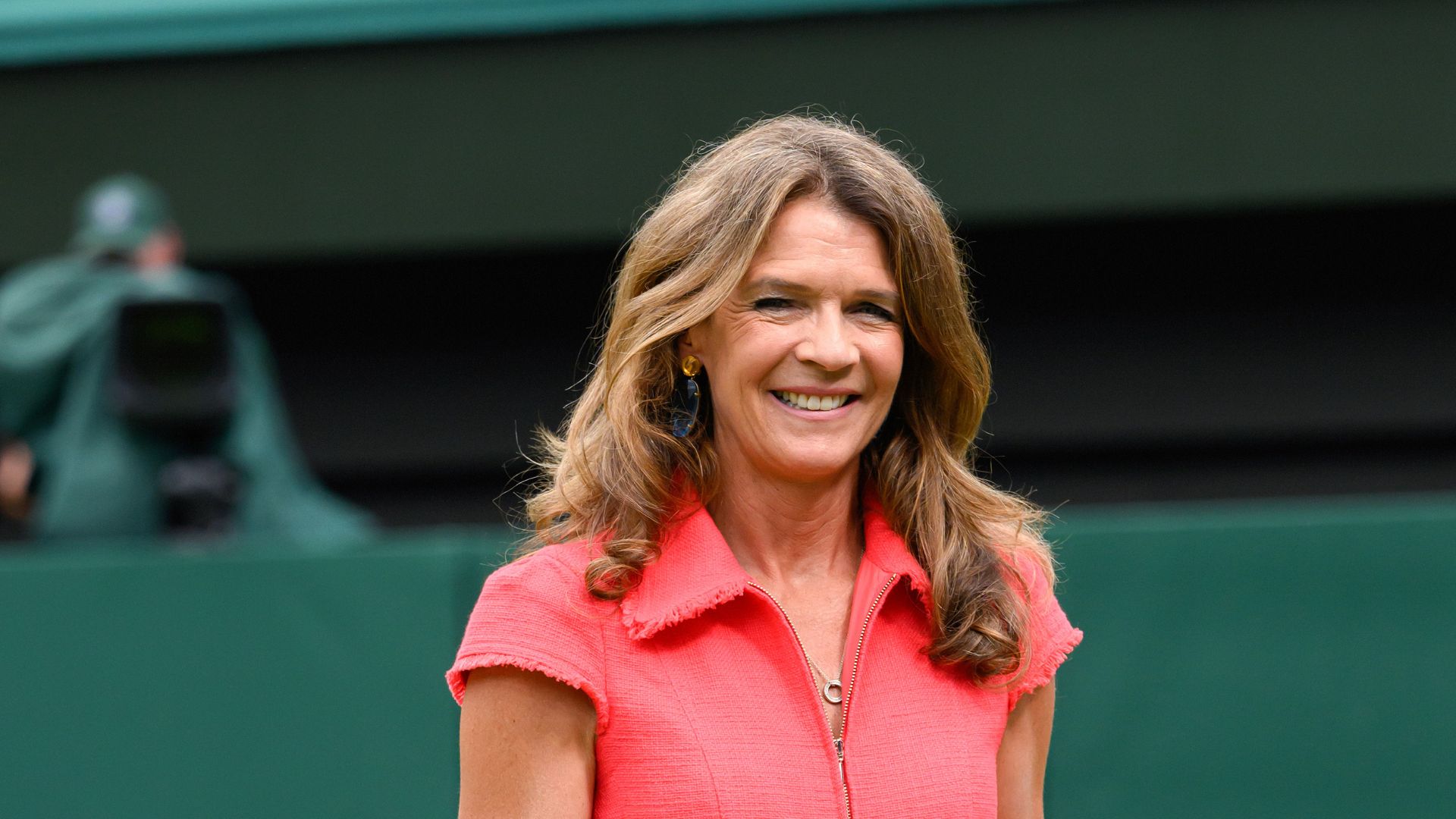 Annabel Croft wearing a red jumpsuit