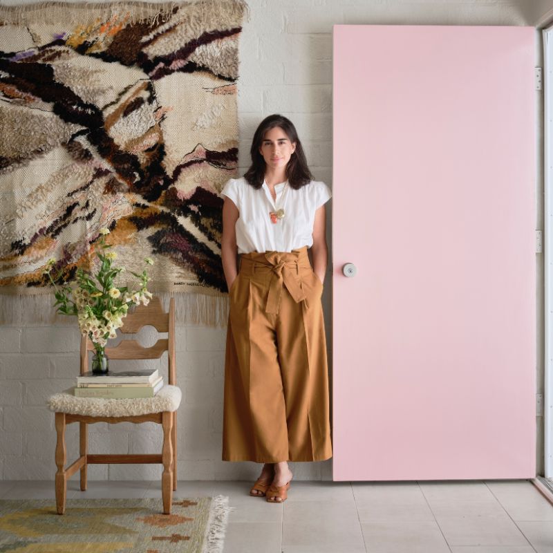  Jessica Jubelirer standing in front of white brick wall and pale pink door