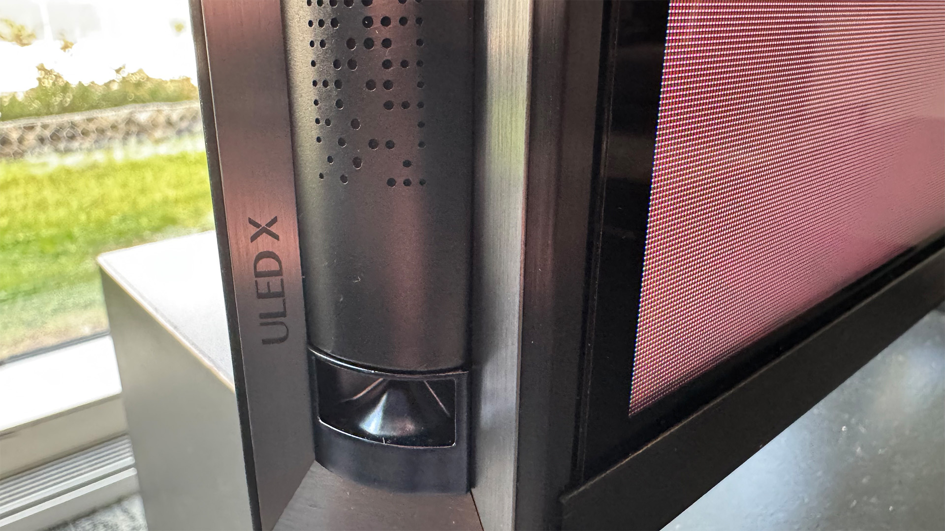 Hisense 116UX RGB Mini LED TV close up on side of TV showing speaker grille and ULED X logo
