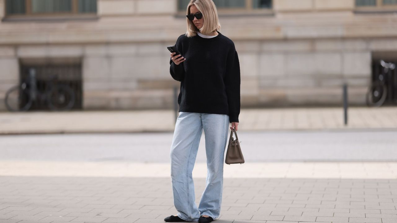 amazon prime day deals - woman looking down at her phone - Getty Images 2143204064