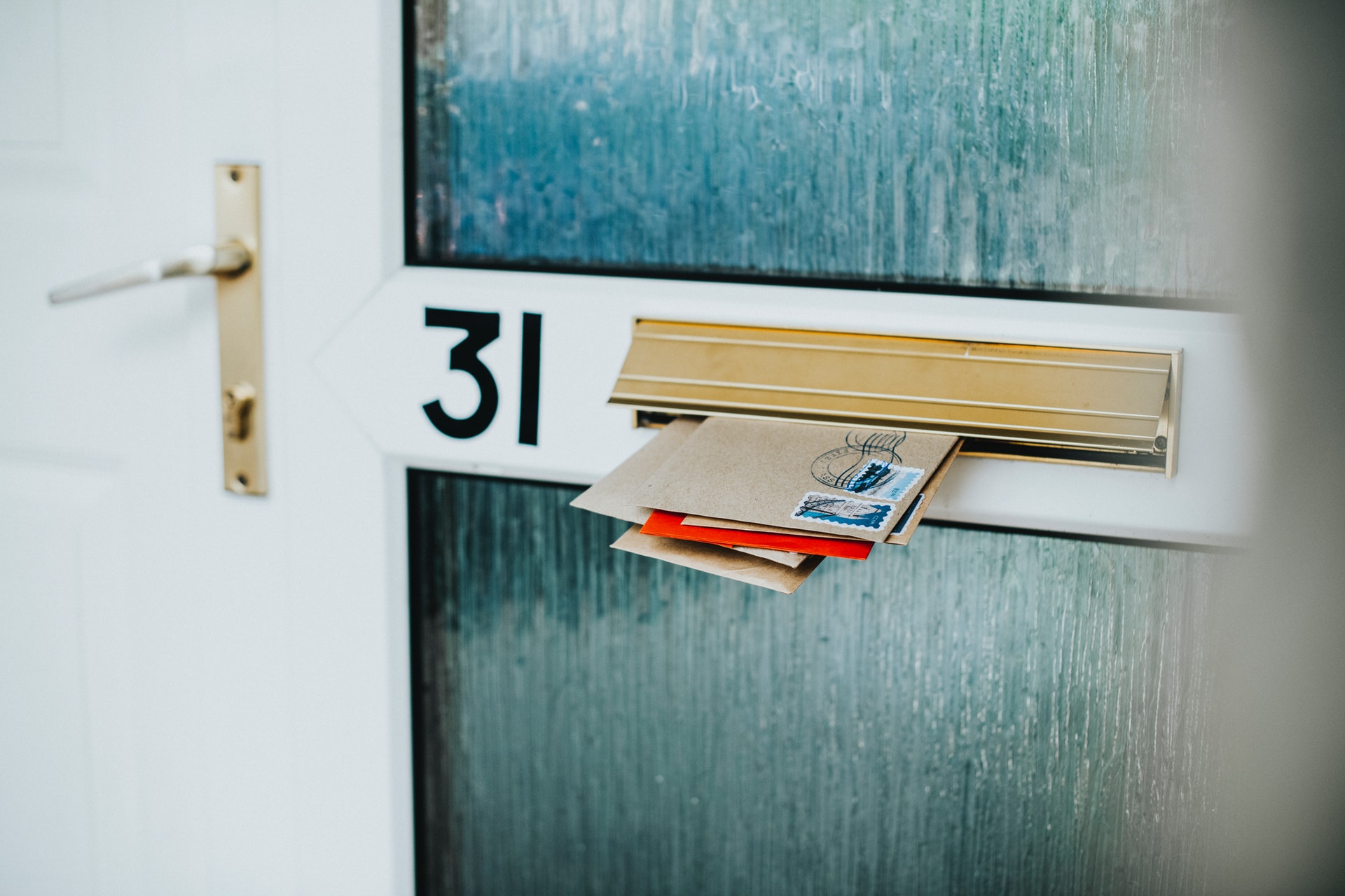 Envelopes stuffed into a mailbox