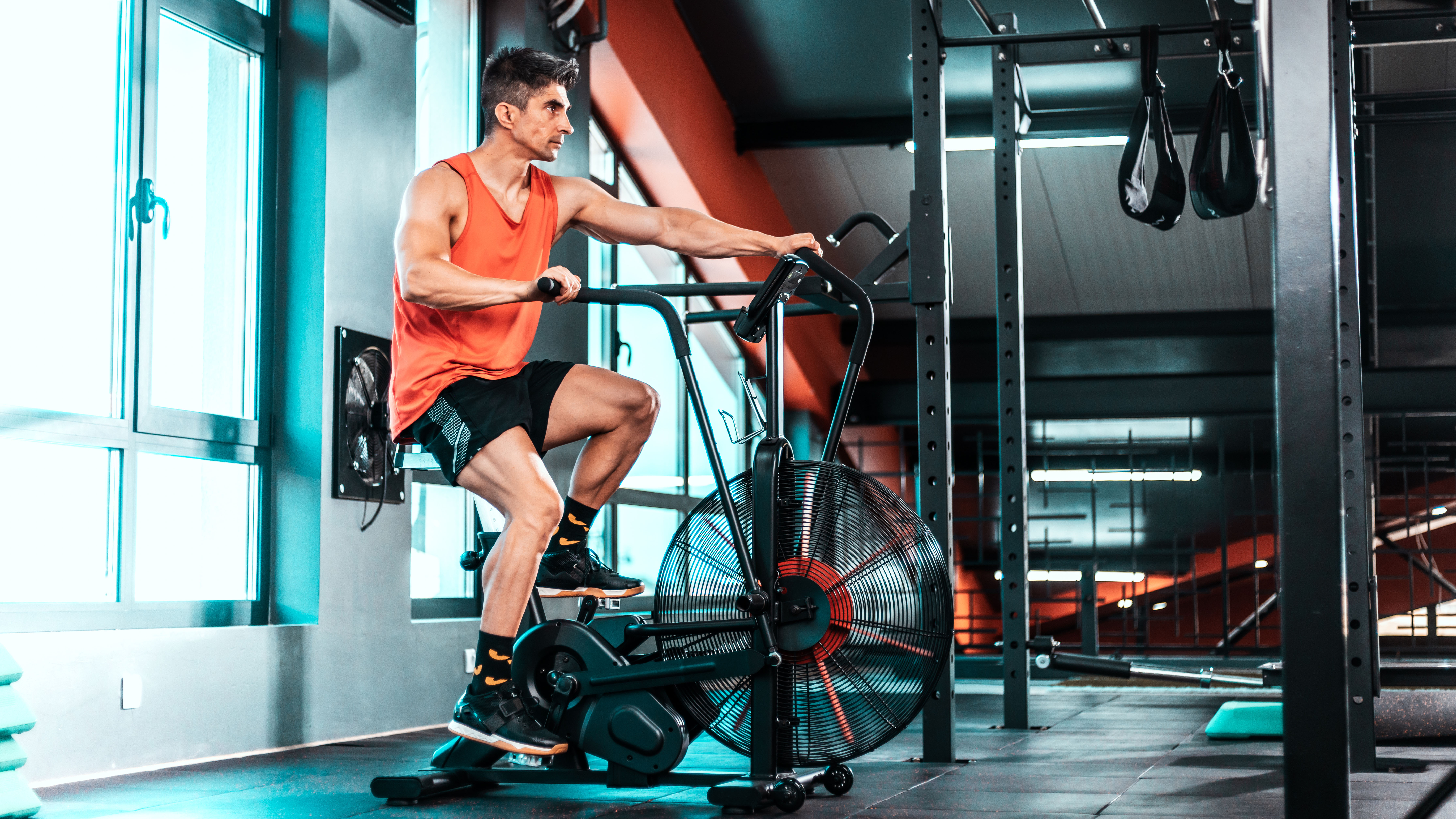 Man in gym on air bike