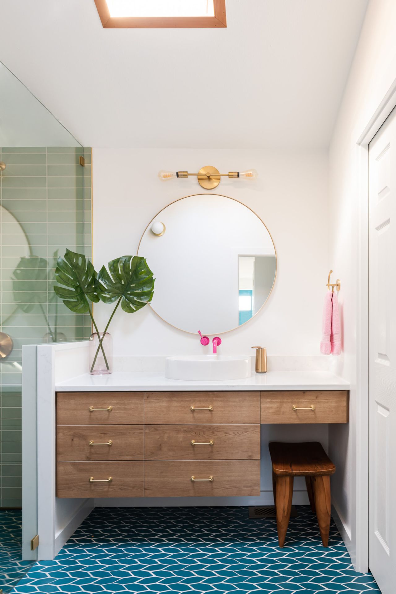 Bathroom with green wall tiles in shower and blue floor tiles