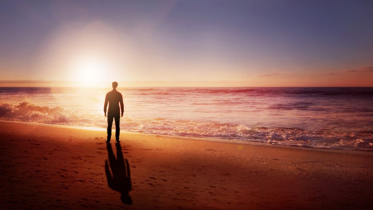 Man on a beach at sunset