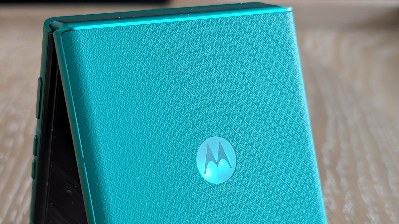 Motorola Razr 2026 in blue, being held in the hand