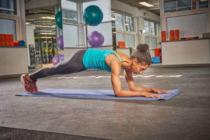 Female cyclist holding a plank position