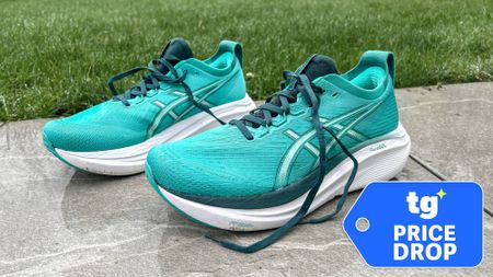 Asics Gel-Nimbus 27 unlaced next to grass