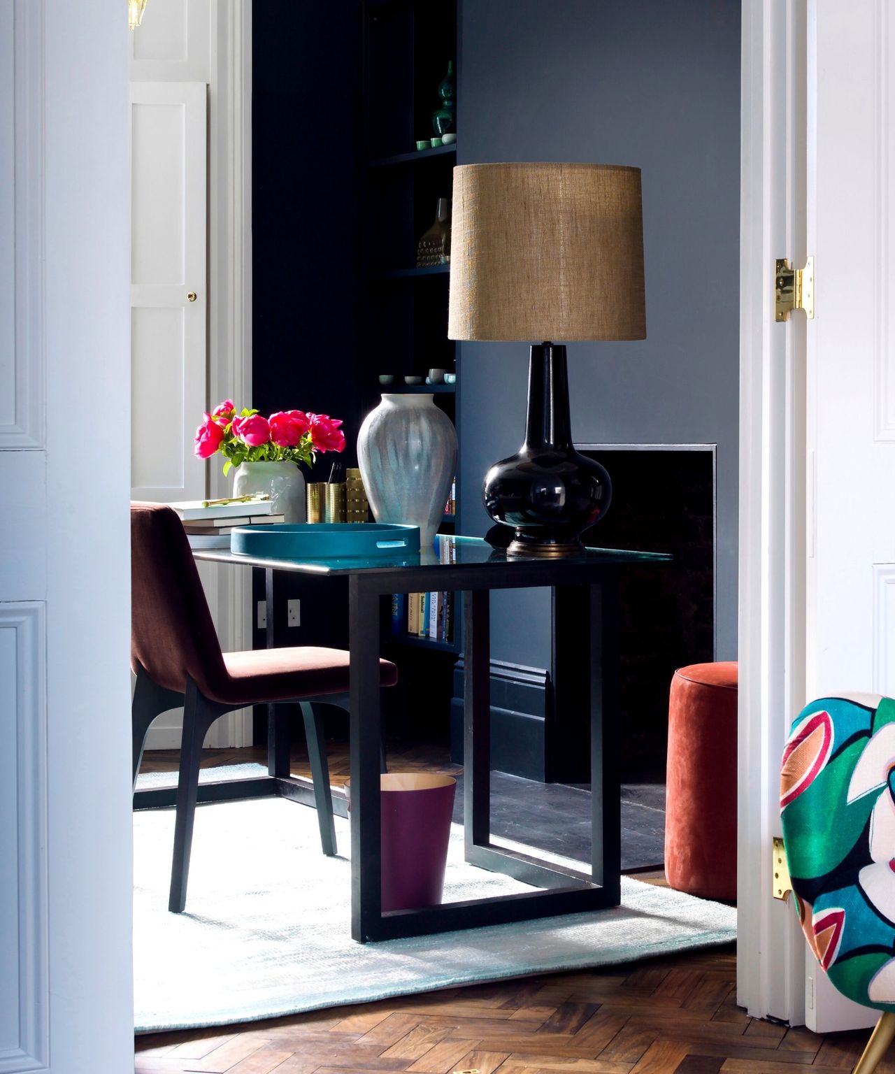 Living room, armchair with abstract pattern, entryway to dining room and home office