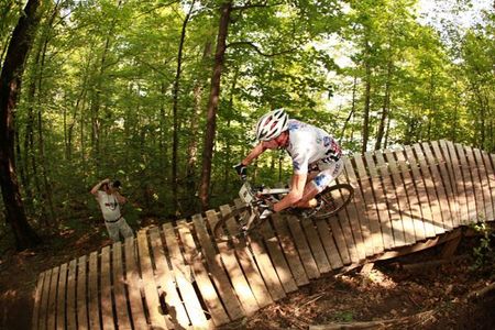 A racer flies through the woods