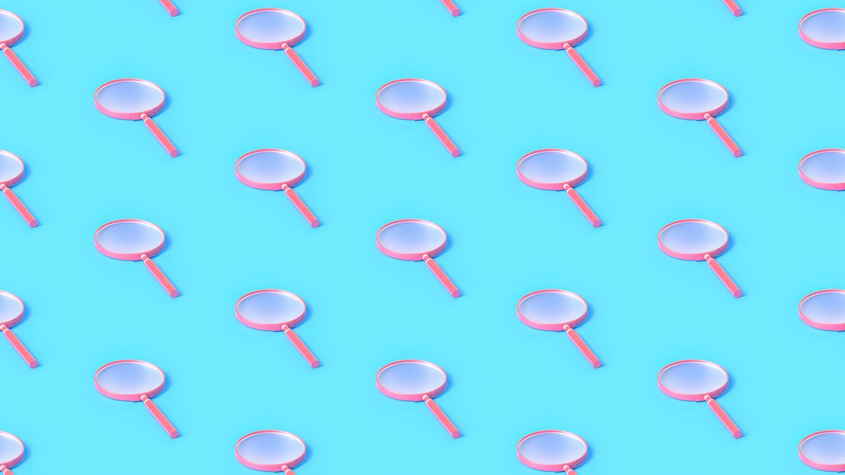 A repeating pattern of pink magnifying glasses on a light blue background