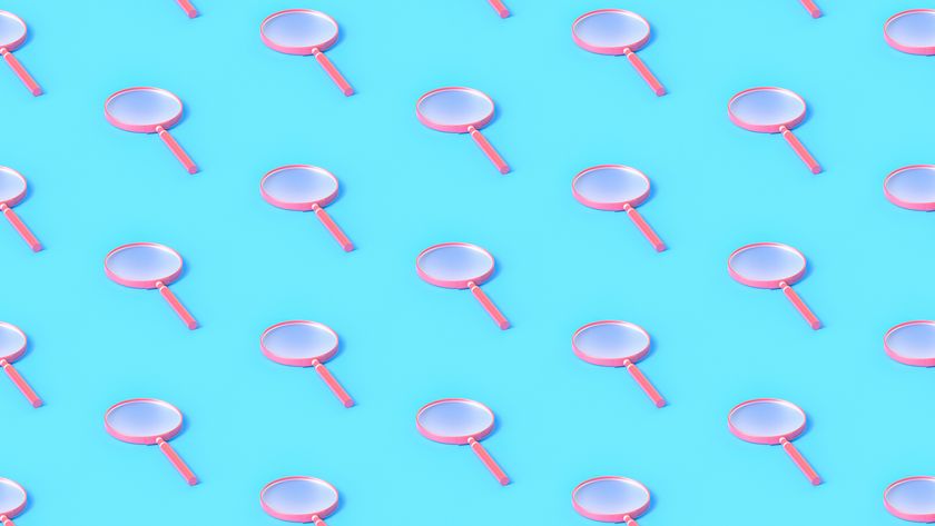 A repeating pattern of pink magnifying glasses on a light blue background