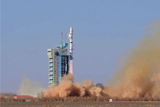 Insulation tiles fall from a Long March 2C rocket carrying the Horus 1 satellite as it rises from the launch pad at Jiuquan spaceport on Feb. 23, 2023.