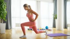 Woman performing lunge exercise in domestic setting