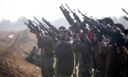 Israeli soldiers prepare weapons in a deployment area on Israel's border with the Gaza Strip on Nov. 19.