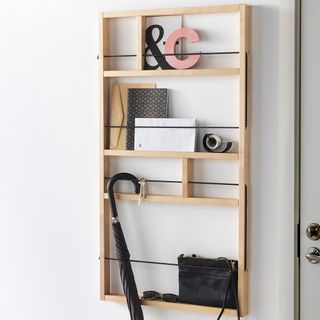 white wall wooden shelf with umbrella and folders