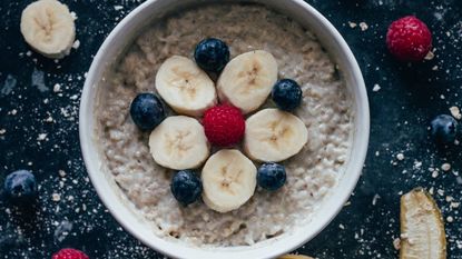 Bowl of oatmeal with fruit on top, wellness tips